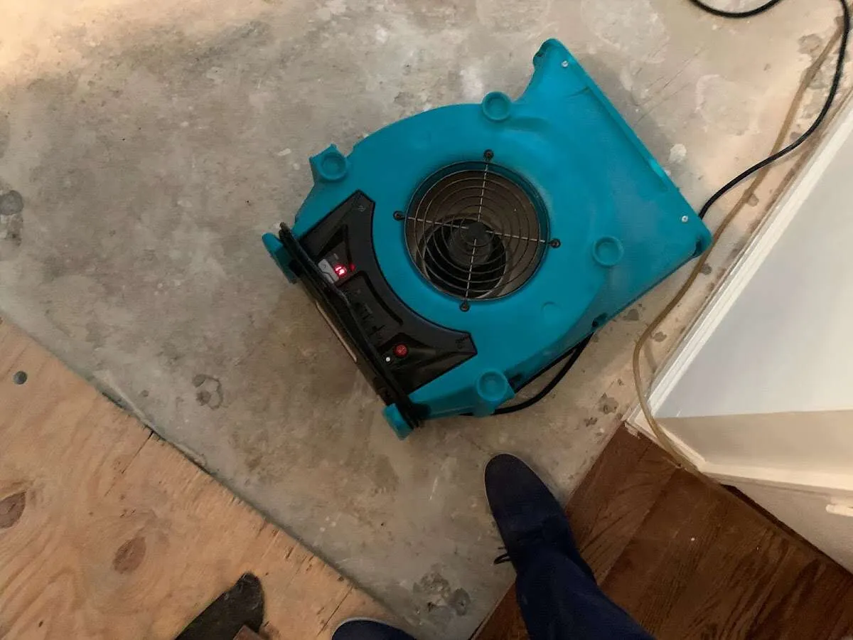 Air mover drying subfloor during Commercial Water Damage Restoration in New Richmond